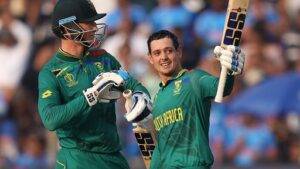 Quinton de Kock of South Africa celebrates their century with team mate Rassie van der Dussen during the ICC Men s Cricket World Cup India 2023 between New Zealand and South Africa